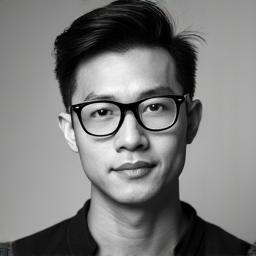 Professional black and white headshot of Alexander Ng, a kind-faced man with a determined expression.